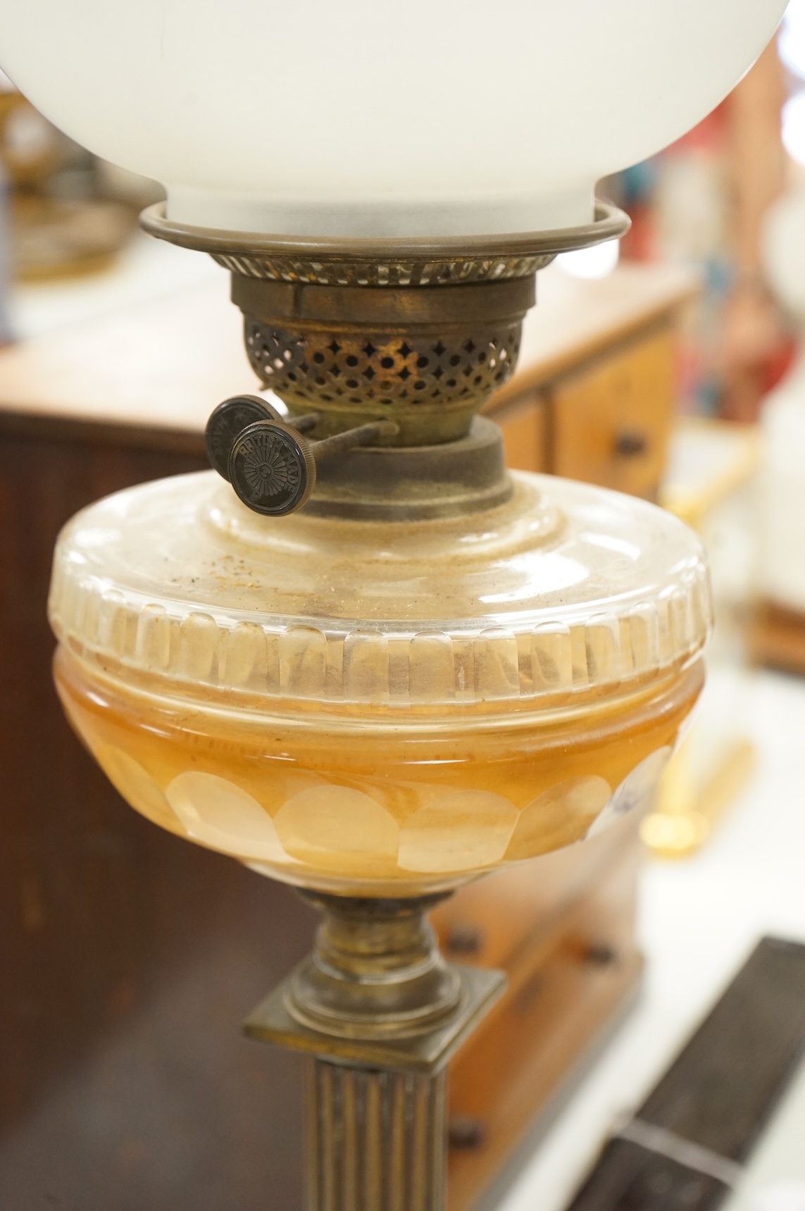 A brass oil lamp with columnar base and etched glass shade, 72cm high overall